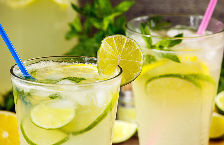Refreshing lemonade drink and ripe fruits