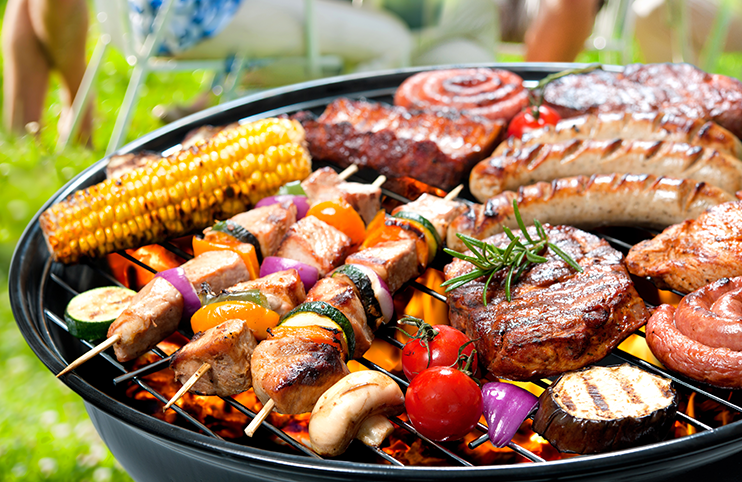 Family having a barbecue party in their garden in summer