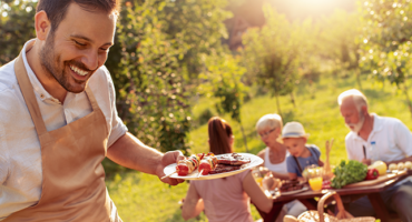 Happy family having barbecue party in backyard.Food,family,fun and happiness concept.