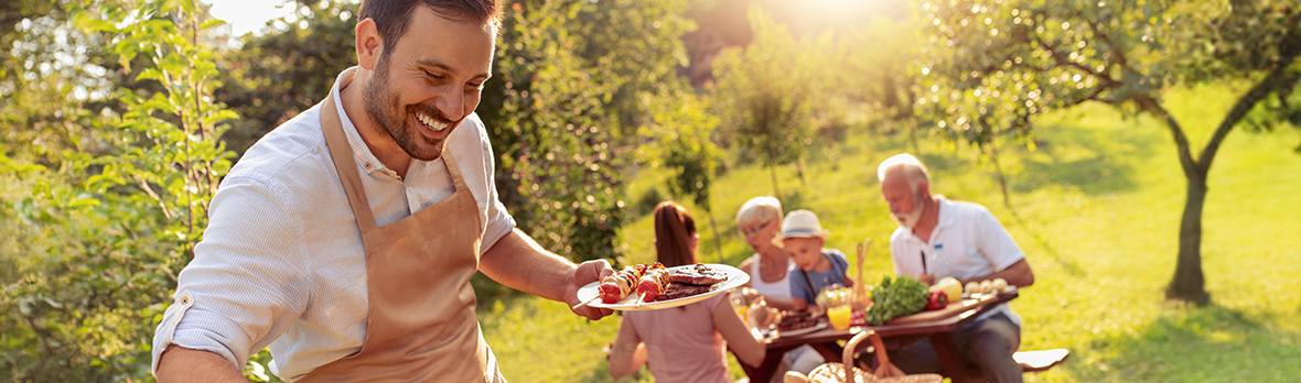 Happy family having barbecue party in backyard.Food,family,fun and happiness concept.