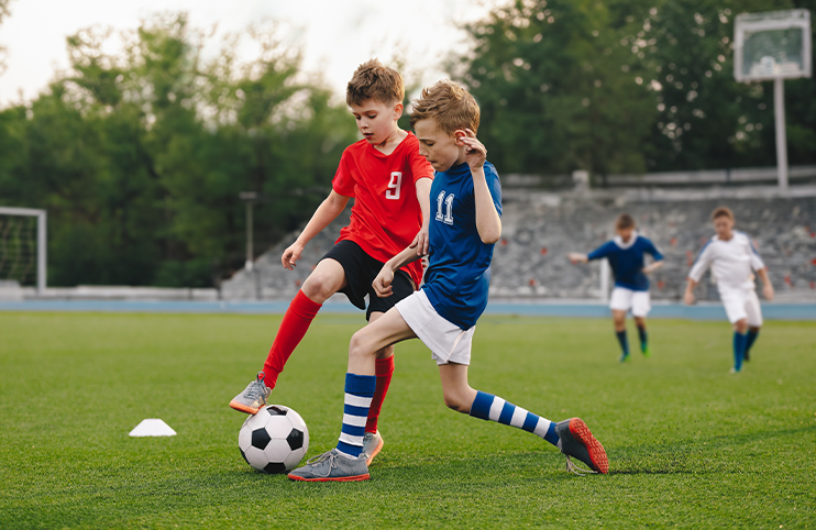 Boys playing football game